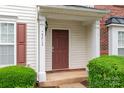 Close-up of the front porch featuring a wood door, white columns, and house number at 4213 Coulter Xing, Charlotte, NC 28213