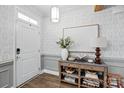 Bright foyer with elegant wallpaper, modern lighting, and stylish console table at 4842 Durneigh Dr, Kannapolis, NC 28081