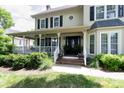 Inviting front porch with white railings, comfortable seating, and a glimpse of the home's entrance at 503 New Castle Ne Ct, Concord, NC 28025