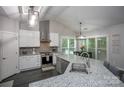 Stylish kitchen with an island, granite counters and stainless appliances at 6009 Swanston Dr, Charlotte, NC 28269