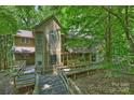 Charming home exterior with a wooden walkway and lush foliage and a view of the nearby pool at 6016 Gray Gate Ln # C, Charlotte, NC 28210