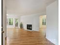 Bright living room with hardwood floors, a fireplace and a view of the green outdoors at 6016 Gray Gate Ln # C, Charlotte, NC 28210