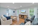 Bright living room with hardwood floors, comfortable seating, and natural light at 6208 Rocky Falls Rd, Charlotte, NC 28211