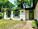 Inviting home featuring neat landscaping and a brightly colored front door at 7228 Rollingridge Dr, Charlotte, NC 28211