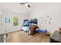 Cozy bedroom with a bunk bed, wood floors, and a bright window overlooking the yard at 7683 Sarah Dr, Denver, NC 28037
