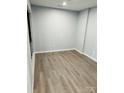 Neutral bedroom featuring modern wood-look floors and freshly painted walls at 8029 Cedar Glen Dr, Charlotte, NC 28212
