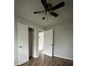 Neutral bedroom featuring wood-look flooring, closet, and a modern ceiling fan at 843 Spring St, Rock Hill, SC 29730