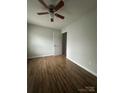 This bedroom boasts a ceiling fan, wood-look flooring, and ample natural light at 843 Spring St, Rock Hill, SC 29730