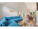 Open concept living area features vaulted ceilings, hardwood floors, and flows into the dining area at 8605 Tamarron Dr, Charlotte, NC 28277