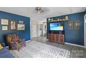 Comfortable living room showcasing a large TV, decor, and access to dining area at 906 Eastwood Dr, Rock Hill, SC 29730