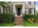 Inviting home entrance featuring brick steps, wrought iron railings, and lush greenery at 9433 Wallace Pond Dr, Huntersville, NC 28078