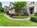 Brick home exterior featuring a beautifully landscaped front yard and inviting entryway at 9433 Wallace Pond Dr, Huntersville, NC 28078