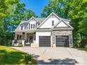 Charming two-story home with a welcoming front porch and a two-car garage at 9712 Worley Dr, Charlotte, NC 28215