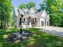 Well-maintained two-story home with lush green lawn and manicured garden at 9712 Worley Dr, Charlotte, NC 28215