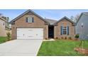 Inviting brick home with a two-car garage, green lawn, and stylish front door at 9924 Manor Vista Trl, Kannapolis, NC 28027