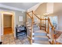 Inviting foyer with staircase, chandelier, tiled floor, and dining area view at 1066 Iveywood Nw Pl, Concord, NC 28027