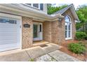 Close-up of the home's front door, showcasing the brick facade and decorative glass window feature at 1066 Iveywood Nw Pl, Concord, NC 28027