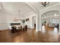 Elegant dining room featuring hardwood floors, wainscoting, and open access to other living spaces at 1152 Grand Oak Dr, Waxhaw, NC 28173