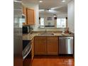 Well-lit kitchen features stainless steel appliances, granite countertops, and opens to the living area at 12238 Paperbark Cir, Charlotte, NC 28277