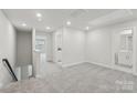 Spacious, carpeted bedroom with a neutral color scheme, natural light, and adjacent bathroom at 124 Utility Ln # B, Mooresville, NC 28117