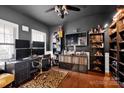 Modern office with dark walls, built-in shelves, and hardwood flooring at 12517 Pine Terrace Ct, Charlotte, NC 28273