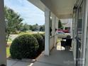 Relaxing covered porch area with outdoor seating overlooking the front yard at 12517 Pine Terrace Ct, Charlotte, NC 28273