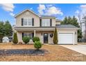 Beautiful two-story house with a well manicured front yard and a convenient attached garage at 130 Valley Glen Dr, Troutman, NC 28166