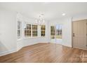 Open living room with hardwood floors, crown molding and lots of natural light at 130 Valley Glen Dr, Troutman, NC 28166