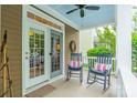 Inviting front porch with rocking chairs, perfect for relaxing and enjoying the neighborhood view, with elegant decor at 16425 Spruell St, Huntersville, NC 28078