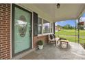 Inviting front porch with seating, a decorative rug, and an attractively painted front door at 1770 Nc 90 W Hwy, Taylorsville, NC 28681