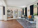Bright living room with custom built-in bookshelves and hardwood floors at 18419 Dembridge Dr, Davidson, NC 28036