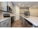 Modern kitchen with stainless appliances, white countertops, and gray cabinets at 1983 Paddlewheel Dr, Stanley, NC 28164