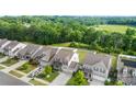Beautiful home with a lush green backyard and a view of the surrounding greenery at 2104 New Hope Branch Way, Belmont, NC 28012
