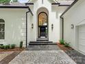Beautiful entry features a dramatic archway, contemporary light fixtures, and patterned walkway at 21404 Blakely Shores Dr, Cornelius, NC 28031