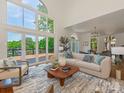This bright living room includes large windows with views and comfortable seating at 21404 Blakely Shores Dr, Cornelius, NC 28031