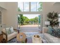 Open living room boasts bi-fold doors opening to a spacious deck and green landscape at 21404 Blakely Shores Dr, Cornelius, NC 28031