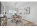 Elegant dining room with chandelier, stylish furnishings, and lots of natural light at 219 Tillery Ln # 755, Mount Gilead, NC 27306