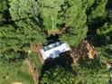 Stunning aerial view of home nestled among lush trees, showcasing its metal roof, landscaping, and privacy at 2268 New Gray Rock Rd, Fort Mill, SC 29708