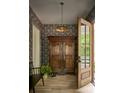 Inviting foyer with hardwood floors, statement wallpaper, and a unique antique armoire for storage at 2268 New Gray Rock Rd, Fort Mill, SC 29708