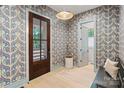 Foyer with patterned wallpaper, hardwood floors, a bench, and a front door with glass panels at 2268 New Gray Rock Rd, Fort Mill, SC 29708