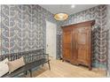 Foyer with patterned wallpaper, hardwood floors, a bench, and a vintage armoire at 2268 New Gray Rock Rd, Fort Mill, SC 29708