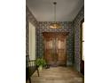 Inviting foyer with hardwood floors, statement wallpaper, and a unique antique armoire for storage at 2268 New Gray Rock Rd, Fort Mill, SC 29708