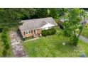 An elevated view of a charming single-story house with a well-kept lawn and mature trees at 2324 Knight Dr, Gastonia, NC 28052
