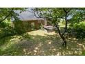 Overhead shot of the backyard of a brick home, featuring a cozy deck and mature shade trees at 2324 Knight Dr, Gastonia, NC 28052