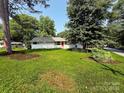 Lovely single-story home with mature trees and a lush green lawn at 2469 Elkwood Cir, Charlotte, NC 28205