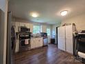 Kitchen with white cabinets, stainless steel appliances and luxury vinyl plank flooring at 290 Greentree Dr, Rock Hill, SC 29730