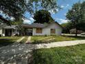 Charming single story home with carport, concrete driveway and grass yard at 306 E Arch St, Lancaster, SC 29720