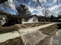 Quaint single story home with grass yard, carport and concrete driveway at 306 E Arch St, Lancaster, SC 29720