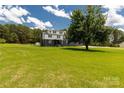 Charming two-story home with a lush green lawn, complemented by mature trees and a serene setting at 330 Skyview Dr, Catawba, SC 29704