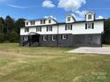 Striking two-story home featuring a white upper level and a dark gray lower level with black shutters at 330 Skyview Dr, Catawba, SC 29704